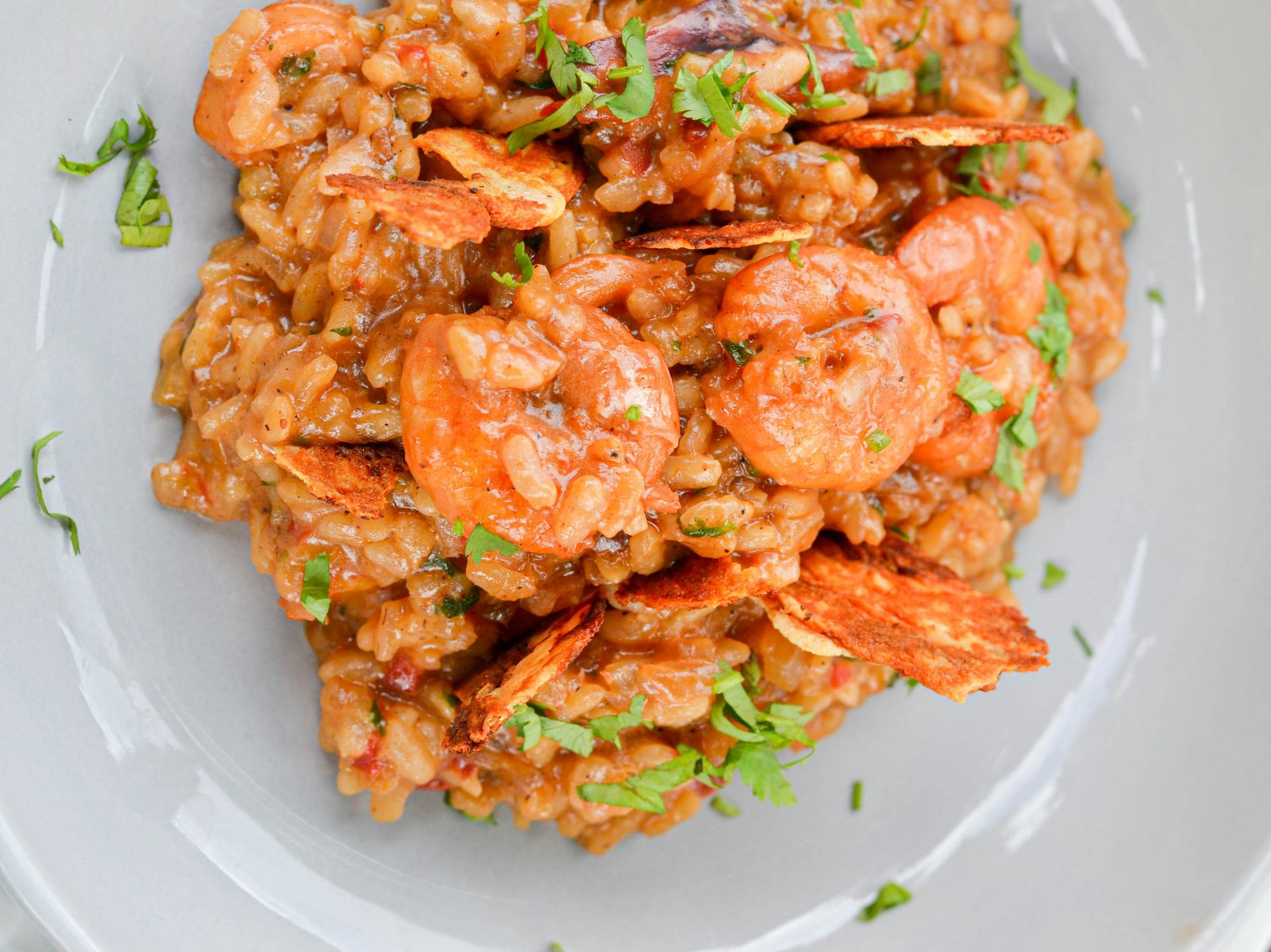a white plate topped with rice covered in shrimp